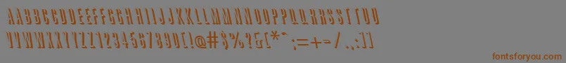フォントGreatshadowbackslantRegular – 茶色の文字が灰色の背景にあります。