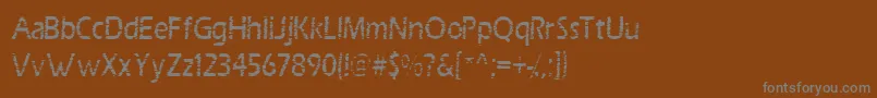 Scrab-fontti – harmaat kirjasimet ruskealla taustalla