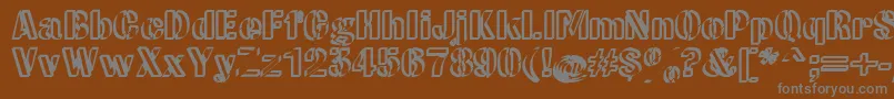 CwRoundwriteNormal-fontti – harmaat kirjasimet ruskealla taustalla
