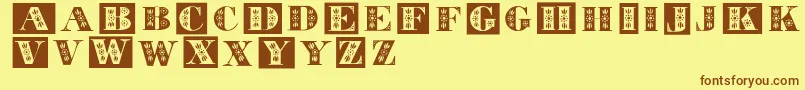 フォントTolecaps – 茶色の文字が黄色の背景にあります。