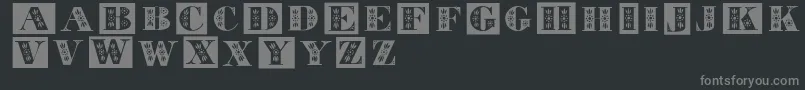 フォントTolecaps – 黒い背景に灰色の文字