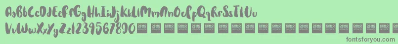 HotCakesDemo-Schriftart – Graue Schriften auf grünem Hintergrund