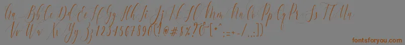 フォントCharlotteCalligraphyR1 – 茶色の文字が灰色の背景にあります。