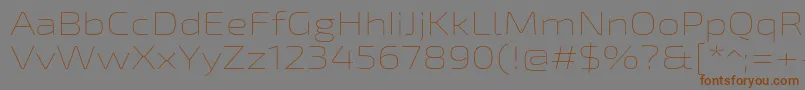 フォントExo2Thinexpanded – 茶色の文字が灰色の背景にあります。