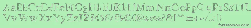 フォントDheMysteriFull – 緑の背景に灰色の文字