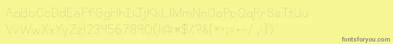 Fonte Kgprimarydots – fontes cinzas em um fundo amarelo