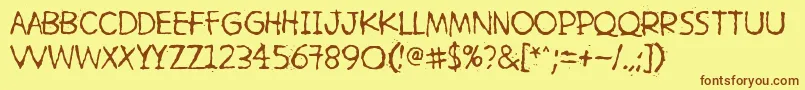 フォントHetkeaMyohemmin – 茶色の文字が黄色の背景にあります。