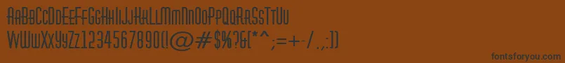 フォントAHuxleycapsBold – 黒い文字が茶色の背景にあります