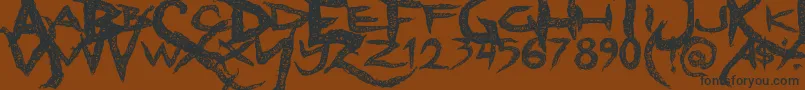 フォントDreadlockfont – 黒い文字が茶色の背景にあります