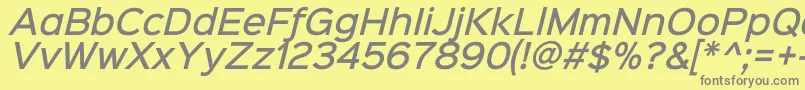 Sinkinsans500mediumitalic-fontti – harmaat kirjasimet keltaisella taustalla