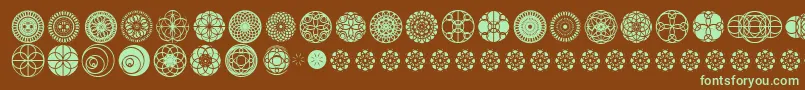 フォントKaleidoscopicVision – 緑色の文字が茶色の背景にあります。