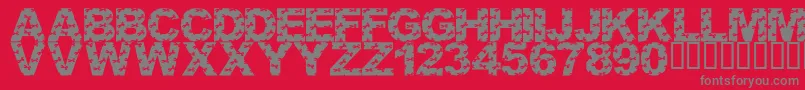 フォントLmsCutItOut – 赤い背景に灰色の文字