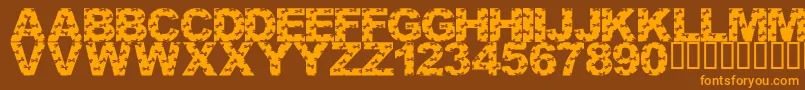 LmsCutItOutフォントについての詳細 フォントLmsCutItOut – オレンジ色の文字が茶色の背景にあります。