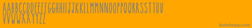 TheskinnyBold-Schriftart – Graue Schriften auf orangefarbenem Hintergrund