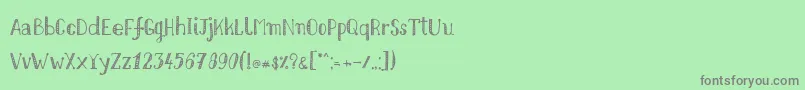 Nikolaidishand Font – Gray Fonts on Green Background
