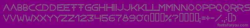 Fonte Perlenkette – fontes cinzas em um fundo violeta