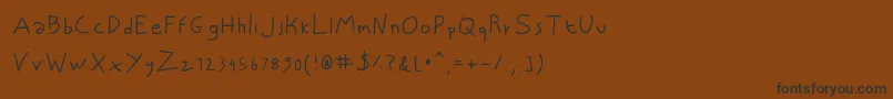 NiscriptRegular Font – Black Fonts on Brown Background