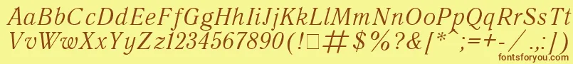 フォントQuantantiquaItalic – 茶色の文字が黄色の背景にあります。