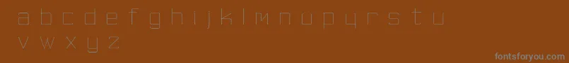 SkinnyMinnie-Schriftart – Graue Schriften auf braunem Hintergrund