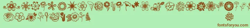 フォントJandaflowerdoodles – 緑の背景に茶色のフォント