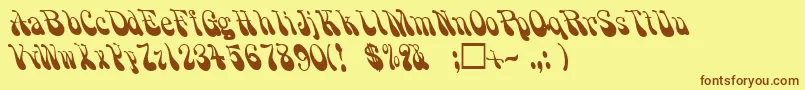 フォントPsychadelicRegular – 茶色の文字が黄色の背景にあります。