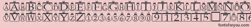 Xmasregular-fontti – mustat fontit vaaleanpunaisella taustalla