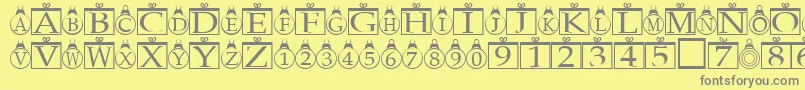 Xmasregular-fontti – harmaat kirjasimet keltaisella taustalla