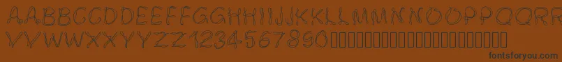 Pwsmokey-Schriftart – Schwarze Schriften auf braunem Hintergrund
