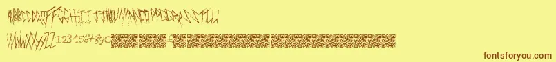フォントFreakymanor – 茶色の文字が黄色の背景にあります。
