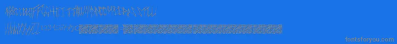 Freakymanor-fontti – harmaat kirjasimet sinisellä taustalla