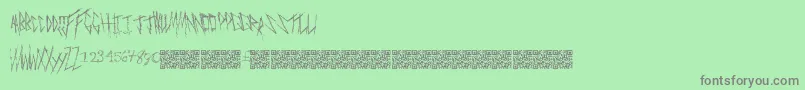 Freakymanor-fontti – harmaat kirjasimet vihreällä taustalla