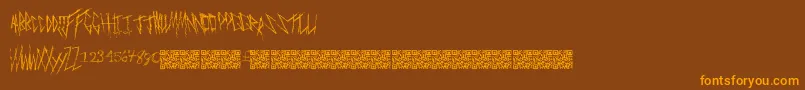 フォントFreakymanor – オレンジ色の文字が茶色の背景にあります。