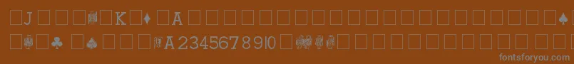 Czcionka HoylePlayingCards – szare czcionki na brązowym tle