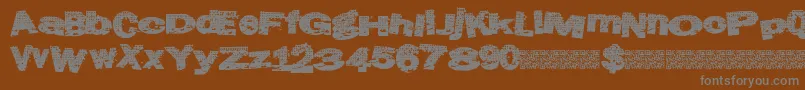 Atlasgrunge-fontti – harmaat kirjasimet ruskealla taustalla
