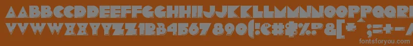 Pacmania Font – Gray Fonts on Brown Background