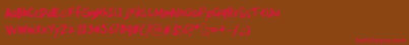 フォントKittypeextra – 赤い文字が茶色の背景にあります。