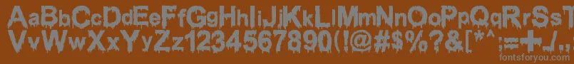 Шрифт WoodcutterDrippingClassicFont – серые шрифты на коричневом фоне