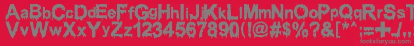 Fonte WoodcutterDrippingClassicFont – fontes cinzas em um fundo vermelho