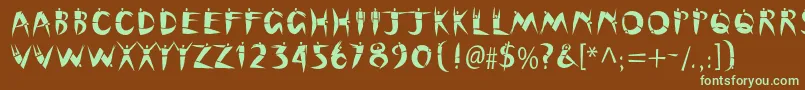 フォントCutoutstd – 緑色の文字が茶色の背景にあります。