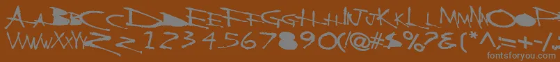 Fonte BackscratcherBold – fontes cinzas em um fundo marrom