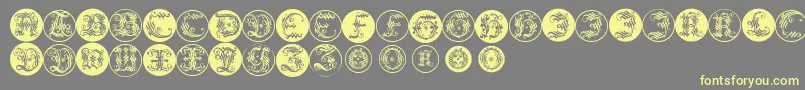 Ornamentalinitialbuttons Font – Yellow Fonts on Gray Background