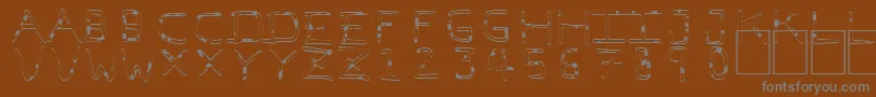 PfVeryverybadfont7Liquid-fontti – harmaat kirjasimet ruskealla taustalla
