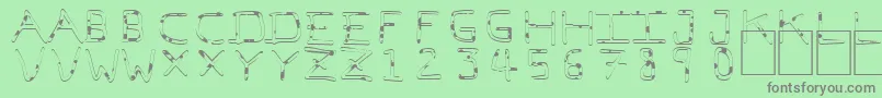 PfVeryverybadfont7Liquid-fontti – harmaat kirjasimet vihreällä taustalla