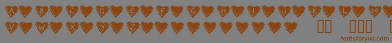Fonte KrScribbleHeart – fontes marrons em um fundo cinza