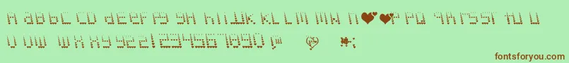 Saiba mais sobre a fonte Naujokslove Fonte Naujokslove – fontes marrons em um fundo verde