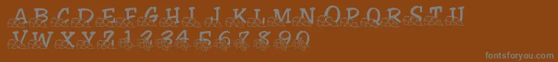 LmsLindalicious-fontti – harmaat kirjasimet ruskealla taustalla