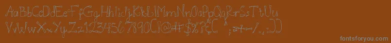 Fonte DjbDoodlEDoo – fontes cinzas em um fundo marrom
