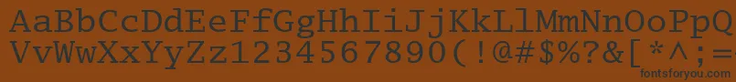 フォントLucidatypewriterstd – 黒い文字が茶色の背景にあります
