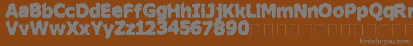 HairyMonsterSolid-fontti – harmaat kirjasimet ruskealla taustalla