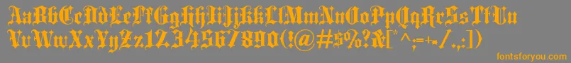 フォントBlackletter – オレンジの文字は灰色の背景にあります。